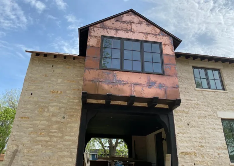 Copper metal panel facade on a stone building for Skylight Installation in Redlands