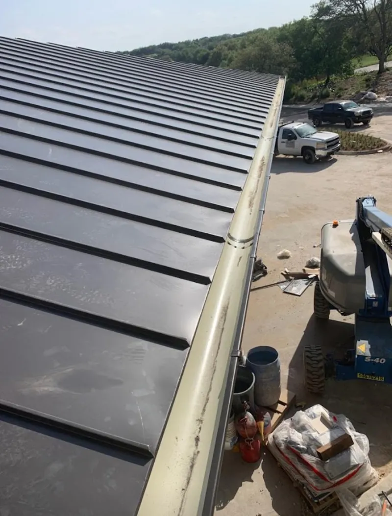 Standing seam panel and gutter detail on a metal roofing jobsite in Redlands